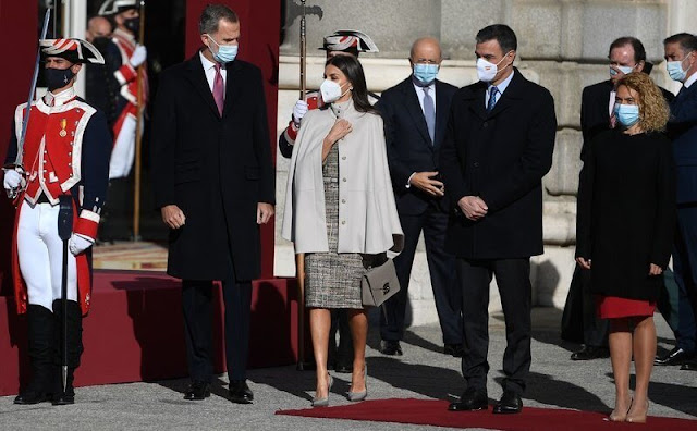 Queen Letizia wore a tweed dress, and a beige cape by Hugo Boss. Magrit pumps. Furla Bag. Laura Mattarella