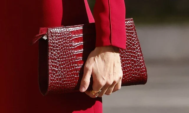 Queen Letizia wore a red dress by Carolina Herrera. Ruby earrings from Joyería Aldao 1911. New red pumps and bag by Magrit