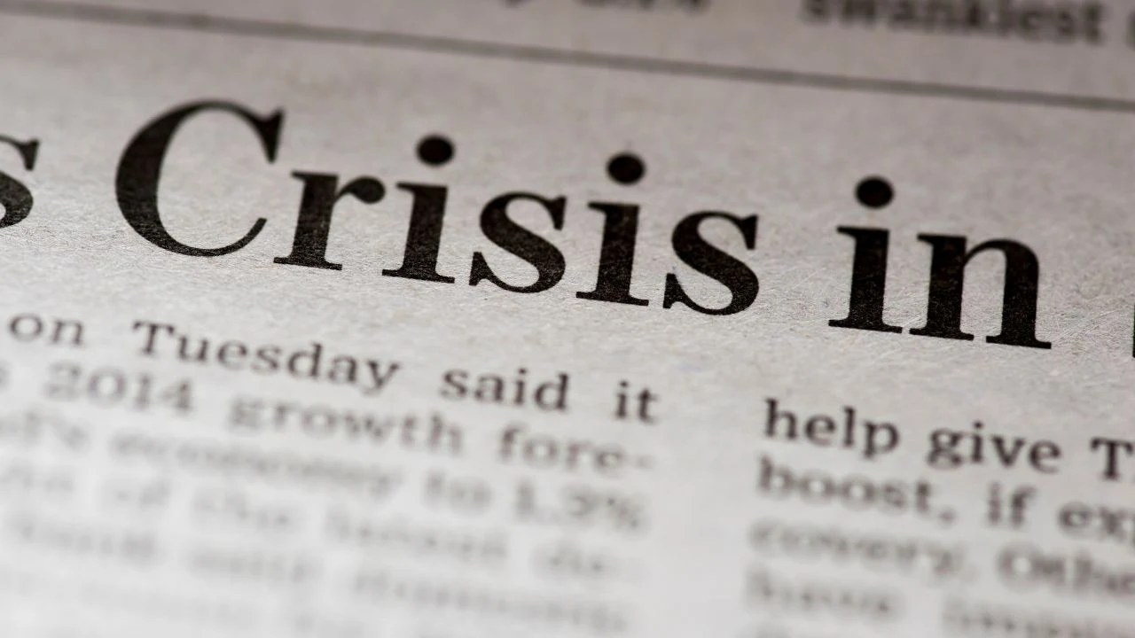 Written crisis on real newspaper with shallow dof.