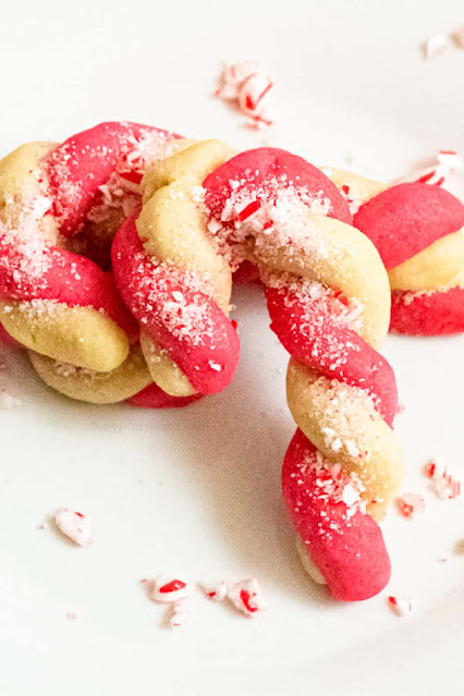 candy cane shaped cookie on a white plate.