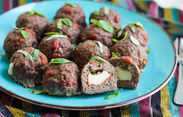 Food Lust People Love: These Pepperoni Pizza Meatballs are seasoned with Italian herbs, onion, garlic, anchovies and sun-dried tomatoes then they are stuffed with pepperoni and mozzarella. Delicious!