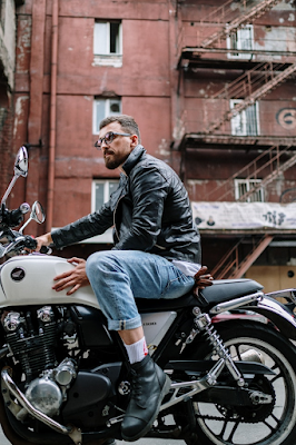 Man Sitting on Motorcycle Wearing a Black Leather Jacket