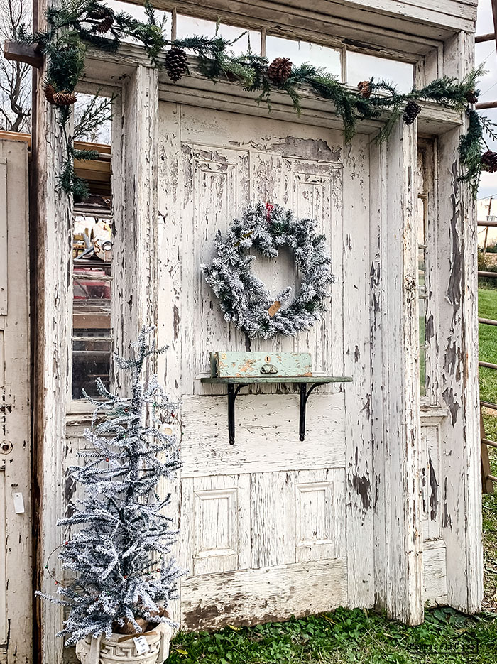chipped white door decorated for Christmas