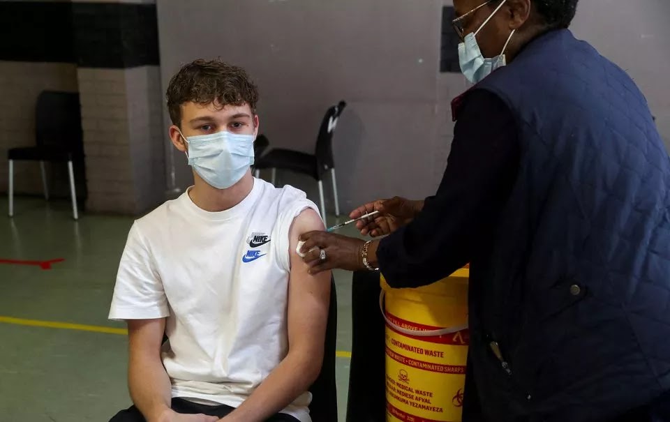 A healthcare worker administers a dose of the Pfizer coronavirus disease (COVID-19) vaccine to a teenager, amidst the spread of the SARS-CoV-2 variant Omicron, in Johannesburg, South Africa, December 9, 2021.