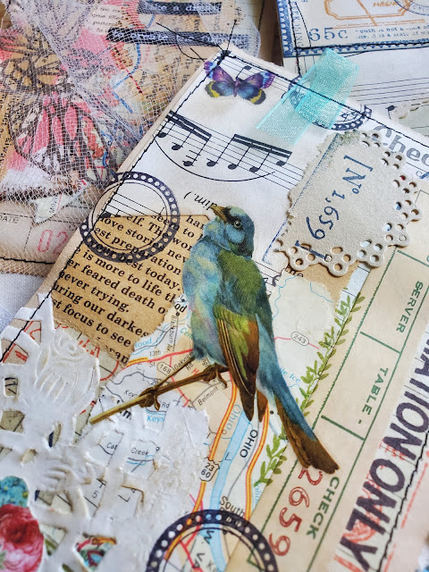 Guest check collaged with beutiful blue bird image and colorful rubber stamps.