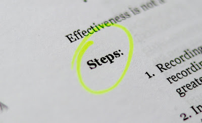 A book page with the letters word "Step" being circled with a highlighter