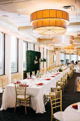 long reception table with gold chiavaris and white linen