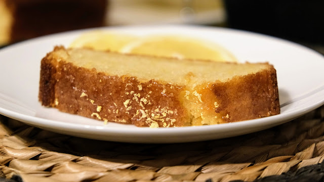 A slice of Vegan Lemon Drizzle Cake on a white plate