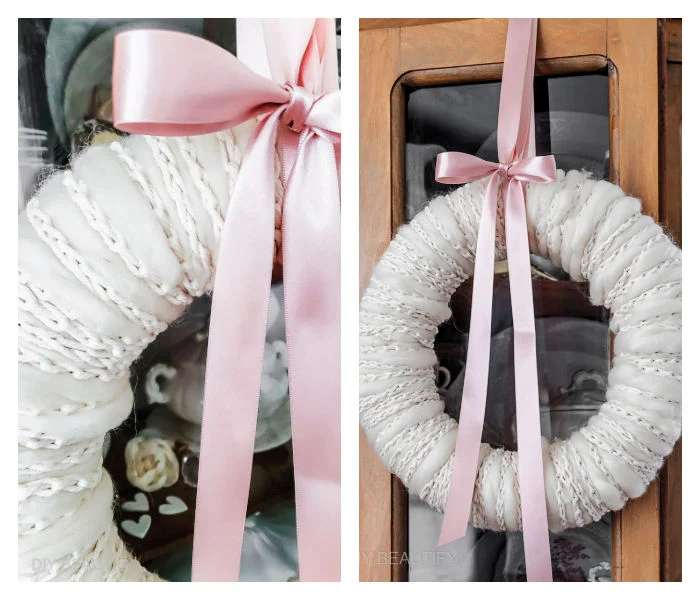 cozy winter wreath hanging from ribbon