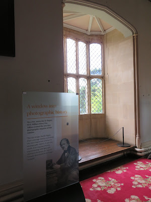 bay window with mullioning and a sign in front of it