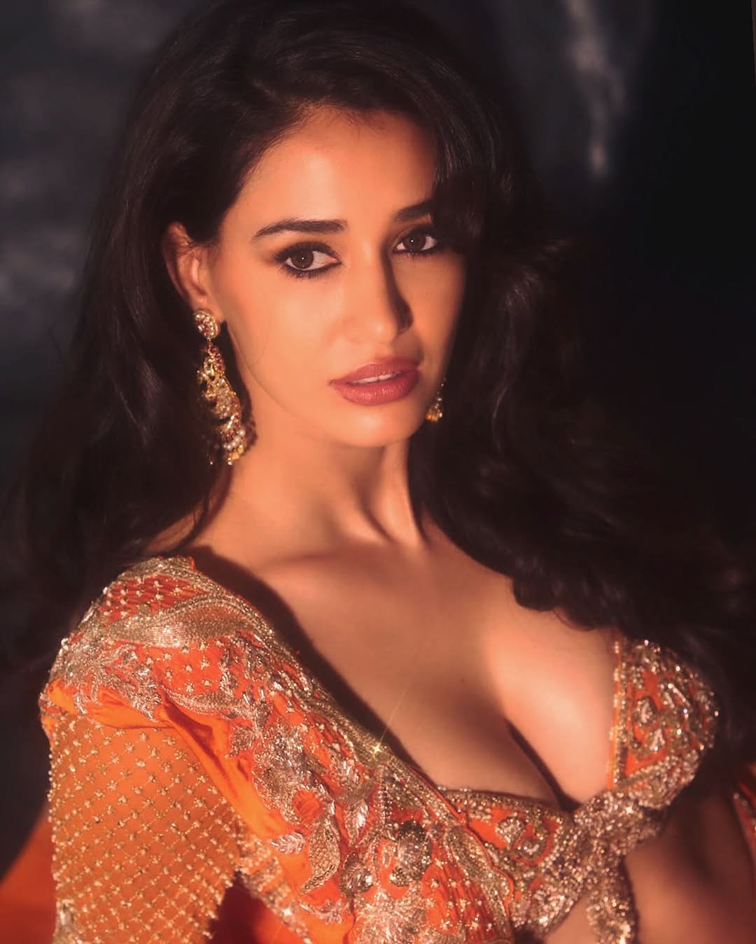 Disha Patani Cleavage Steals the Show in Orange Saree, Navel Tease at MAMI 2025