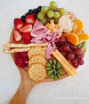 An easy and delicious charcuterie board appetizer is perfect for Christmas, birthday party and any get-together.  Learn how to build an impressive charcuterie board with a variety of fruits, cheese and different treats.