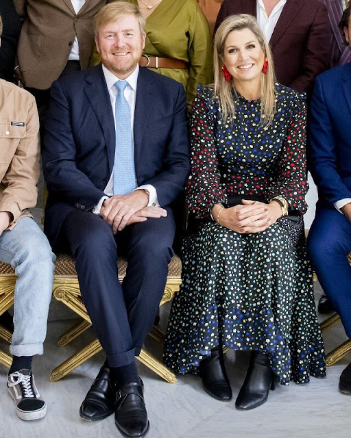 Rixo Billie dress. Queen Maxima wore a mixed ditsy floral tiered midaxi dress by Rixo. Red earrings, lack ankle boots