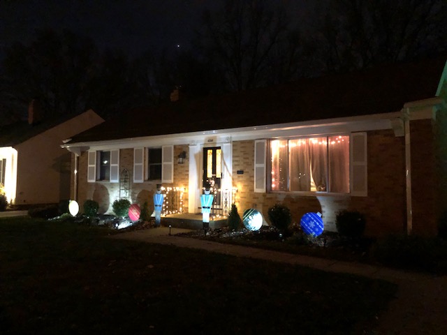 House at night with lawn ornaments