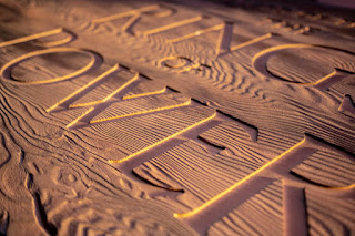 The Rings of Power - words carved out of a piece of wood