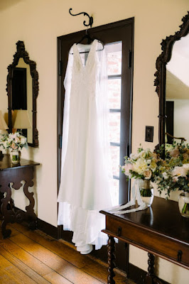 wedding dress hanging on window