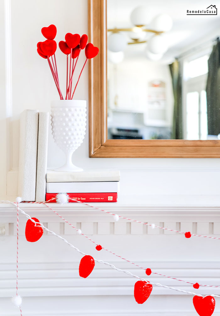 red hearts garland on mantel