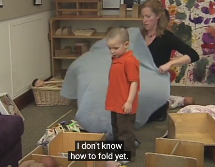 A person and a child in a classroom