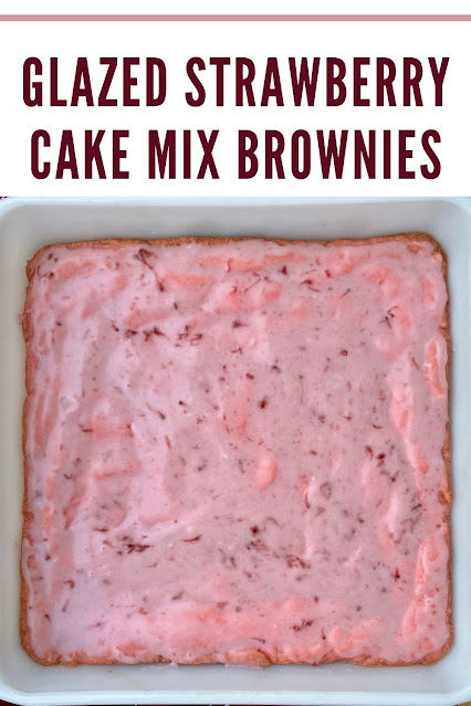 Baking dish of finished glazed strawberry cake mix brownies.
