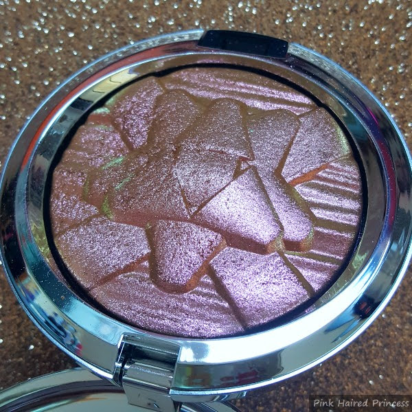 pink metallic highlighting powder in compact with embossed bow design