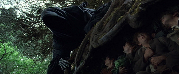 The Hobbits take cover as a Nazgûl searches for the One Ring in THE LORD OF THE RINGS: THE FELLOWSHIP OF THE RING.