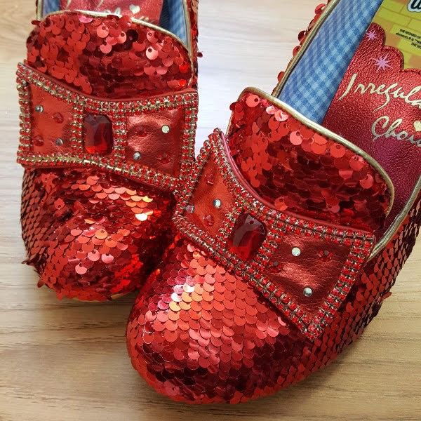 close up of red sequins shoes with light up bow on front