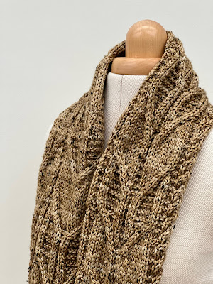 Hand knitted cowl draped on dress form