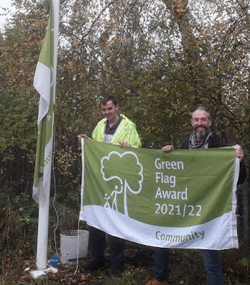 Charlie, a volunteer from Routes 2 Success, (left) was asked to raise the new Green Flag. Pictured with Jason Savage, the course tutor.
