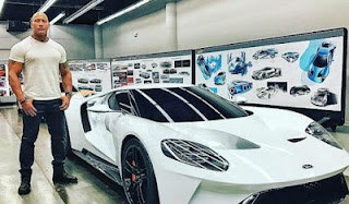 Wanda Bowles's brother The Rock posting for picture with a car