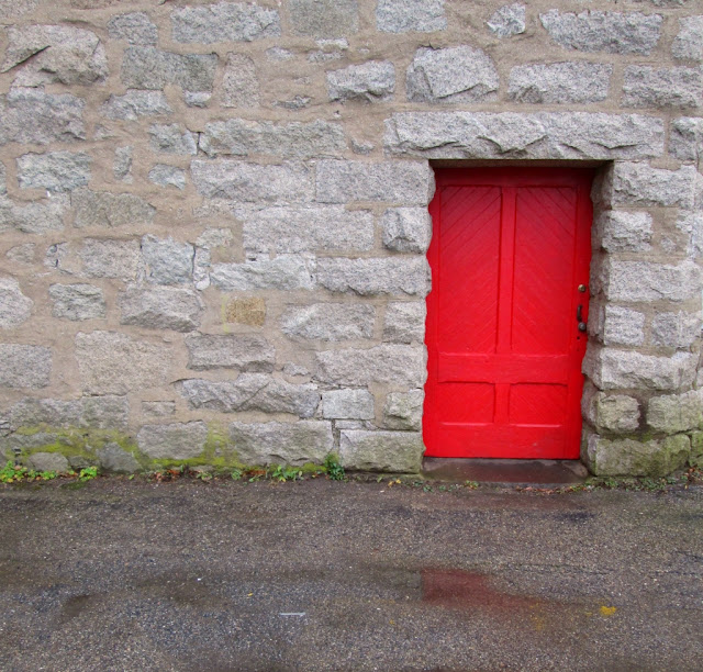 Red door in grey wall