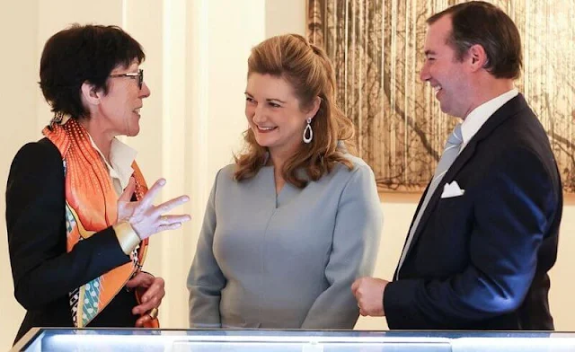 Hereditary Princess Stephanie's outfit is from Belgian fashion house Natan. Tod's satchel grey leather hobo bag. Diamond earrings