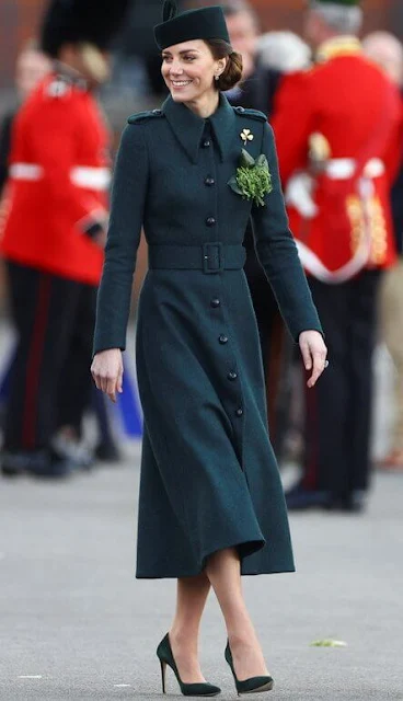 The Duchess wore a new Emilia green coat by Laura Green London. Cartier Shamrock Brooch and diamond and emerald earrings