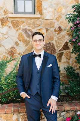 groom in navy suit with black bowtie