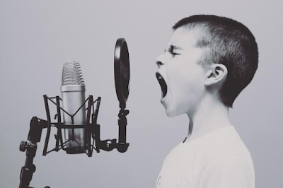 child singing in a studio