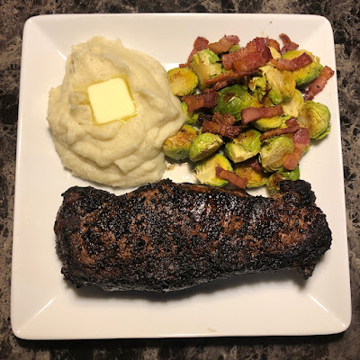 Rare grilled New York strip along with some bacon roasted Brussels sprouts and garlic mashed potatoes