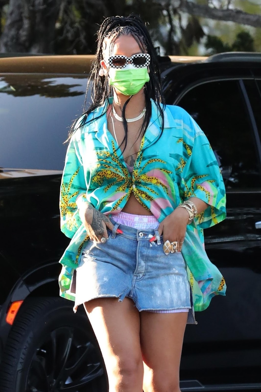 Rihanna is spotted during a grocery run at Bristol in tropical-themed shirt and micro blue jean skirt