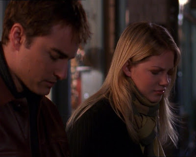 Jack and Jen sitting together on a bus stop bench