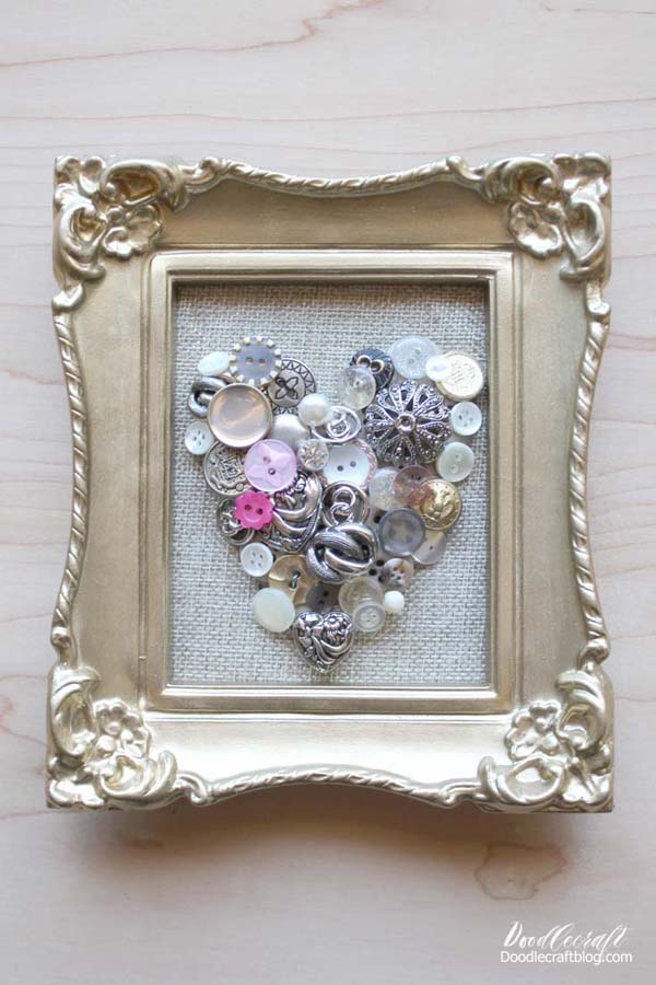 I love the combination of old and new.  Rustic and polished.  Those polar opposites make the perfect pairs.  This button art is sparkly and vintage...with rustic burlap and a gilded frame!  It's easy to make and can you believe it just takes 15 minutes!?  Quick crafts are my favorite. Just a few supplies and a little bit of time make this a super darling decoration for Valentine's day or any day of the week. We could all use a little extra love in our life, right!? This heart is perfection.