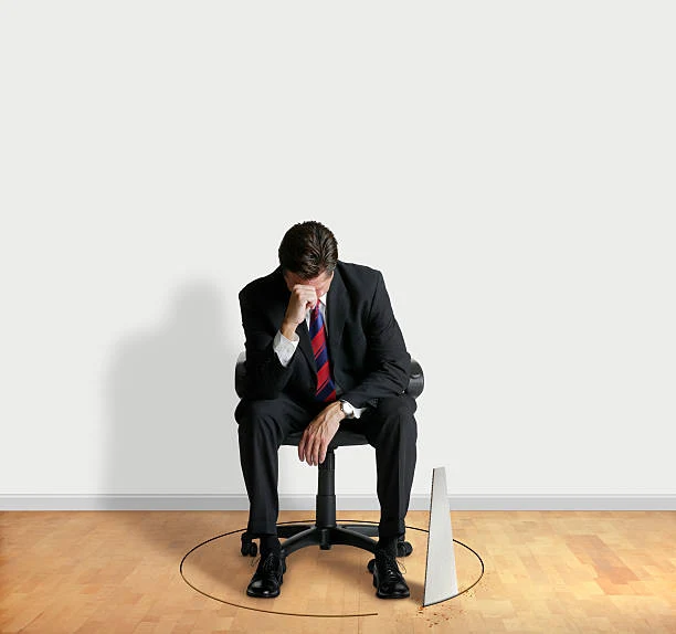 A stressed and depressed businness man is sitting in chair