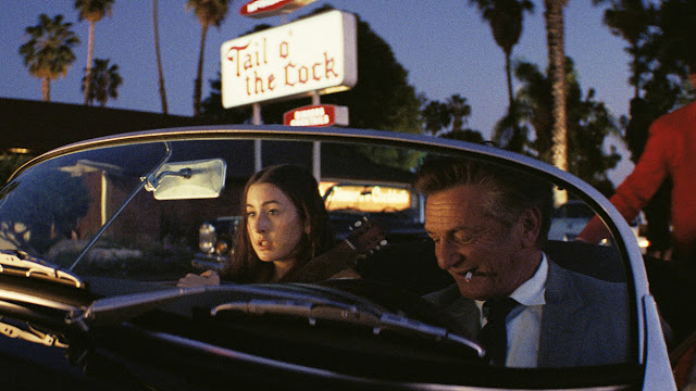 alana haim and sean penn in a convertible