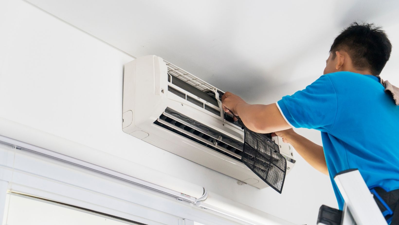 stock image from canva of someone changing an air conditioning filter