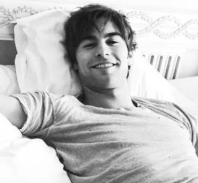 Chace Crawford lounging in bed smiling