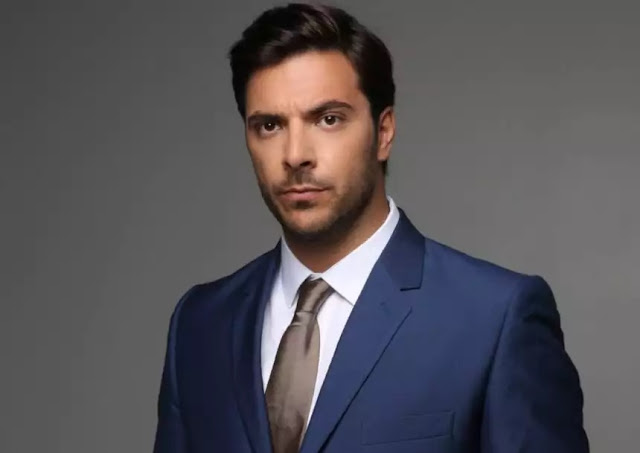 Panos Natsis in wearing a light blue suit