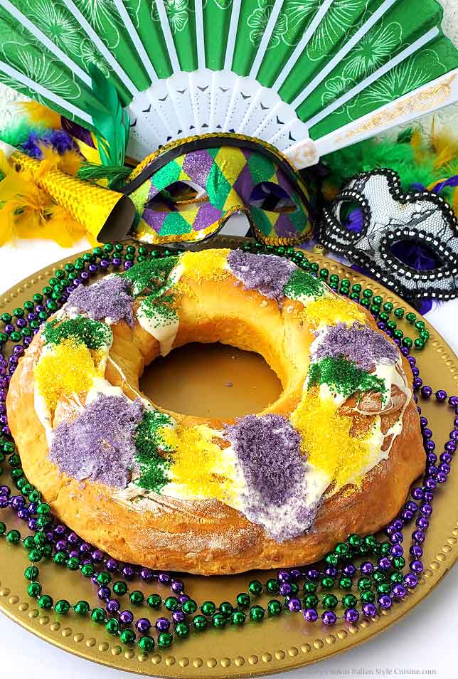 this is a yeast risen King cake with purple, yellow and green sugar for a Mardi Gras party theme