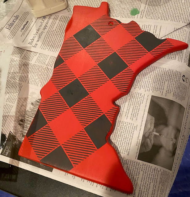Photo of a Minnesota shaped cutting board painted and buffalo checked with a stencil.