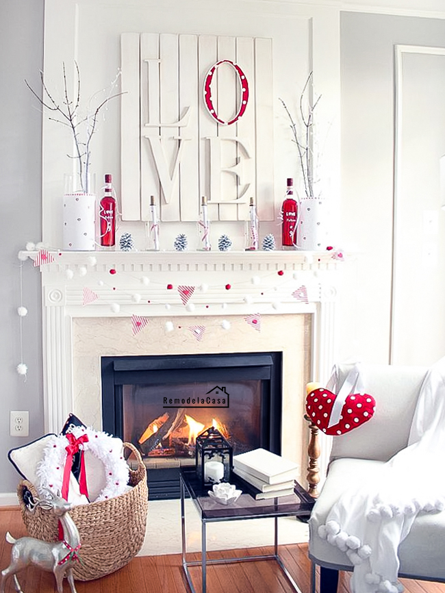 Valentine mantel with branches, love art and pom pom garland