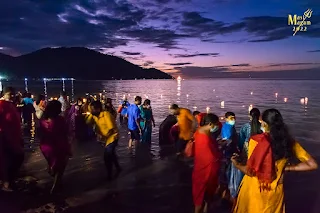 Devotees throng to the water edge to release their lamps onto the sea after the float has left the beach