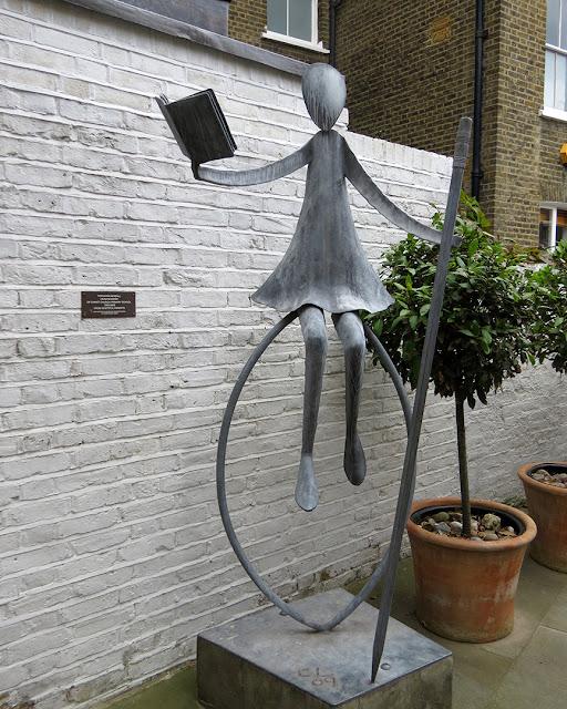 Girl reading, balancing on hoop with pencil by Christopher Linsey, for Anna Kendall, headteacher of Christ Church Primary School, Robinson Street, Chelsea, London