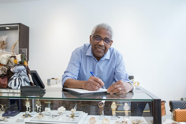 A happy elderly gentleman working as a jeweler.