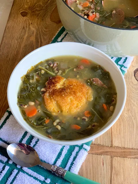 Black Eyed Peas and Collards Soup, a flavorful soup, combines two southern favorites, black eyed peas and collards with carrots and lean ham.  Drop a hot water cornbread medallion in the center of the bowl of soup that will leave you full but not weighed down.